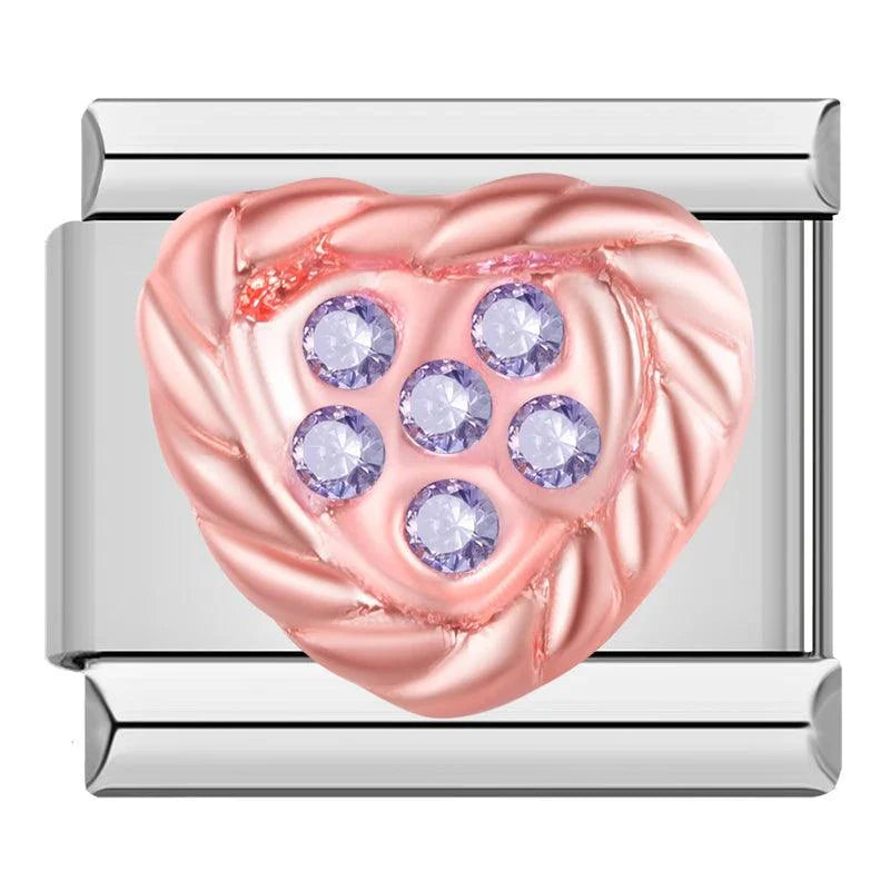 Corazón rosado con piedras moradas, en plateado